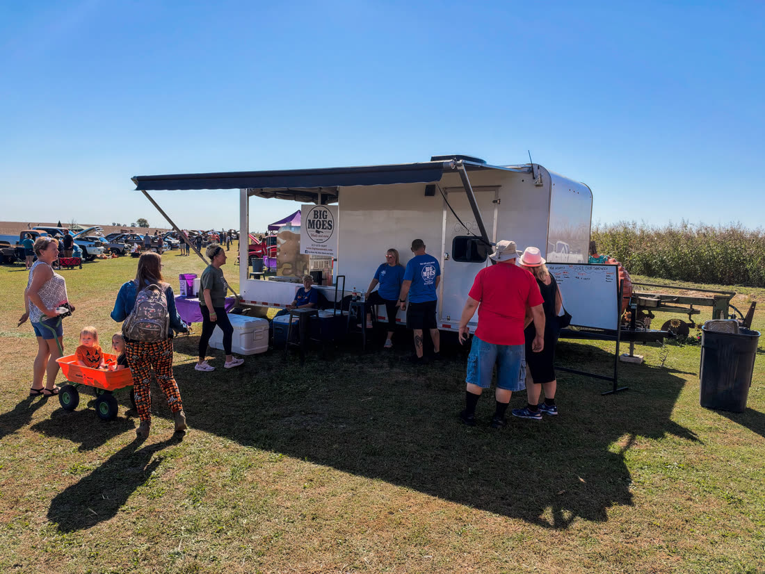 Customers lined up at the Big Moe's trailer under the awning at Wagon Wheel Pumpkin Farm