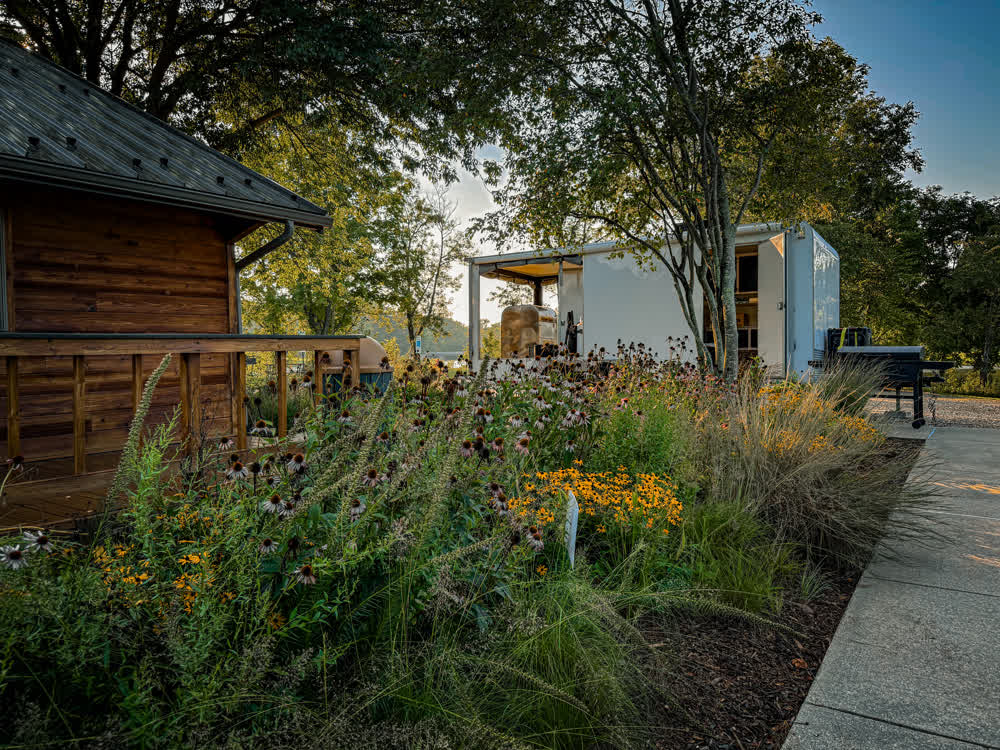 Big Moe's trailer set up on-site among native wildflower gardens for an event
