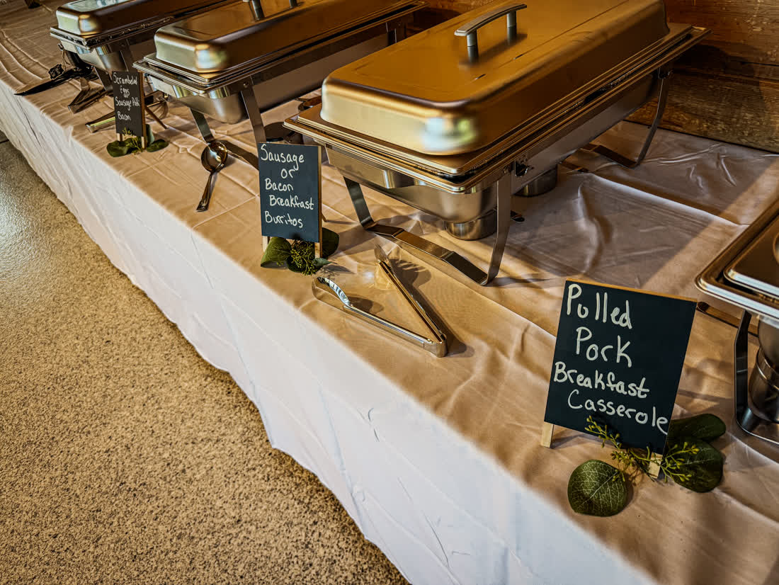Chafing dishes labeled Sausage or Bacon Breakfast Burritos and Pulled Pork Breakfast Casserole